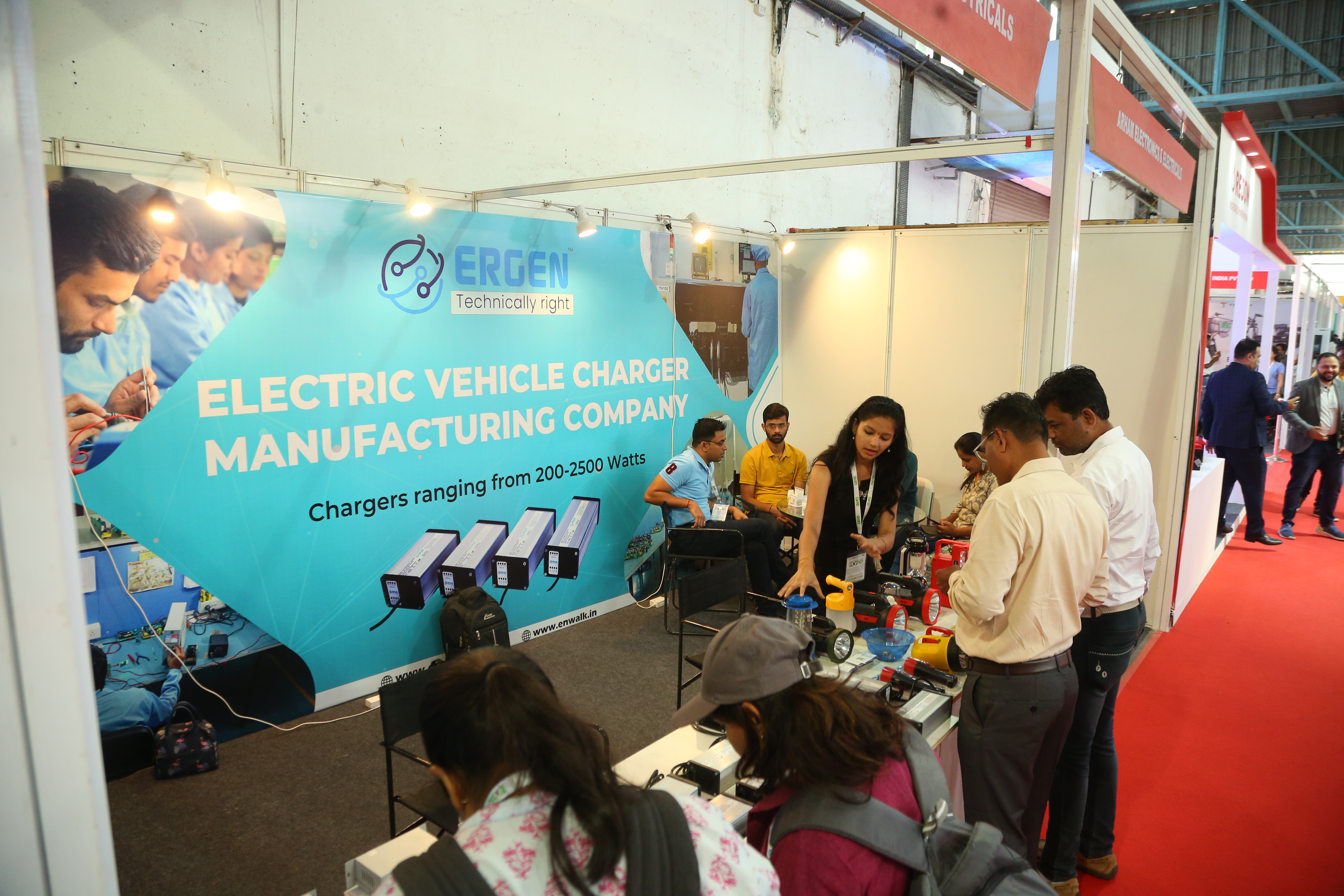 EV charger exhibitors demonstrating products at Maha Expo